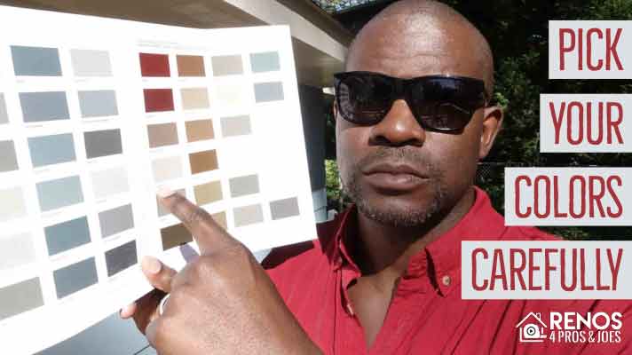 man in sunglasses pointing a stain color chart