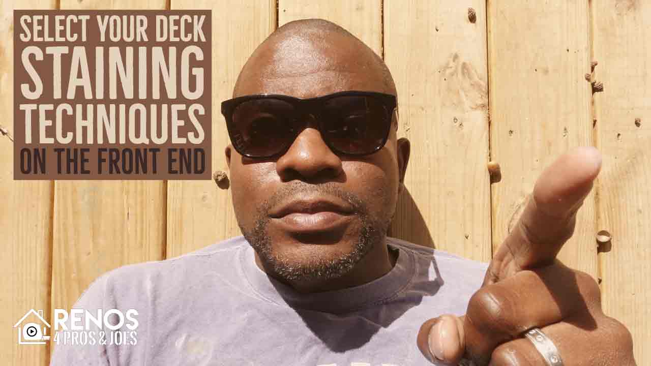 man laying on a wood deck floor wearing sunglasses and pointing his finger